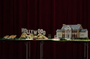 Diorama on table with gold records, Hollywood hills, Graceland, figures and cars, QR codes and touch buttons