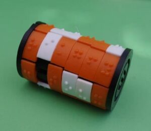 3D printed cylinder with 6 by 6 sliding pieces, each with a braille letter
