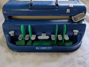 plastic base with blades between the keys on a Perkins brailler