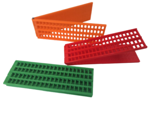 brightly coloured plastic braille slates